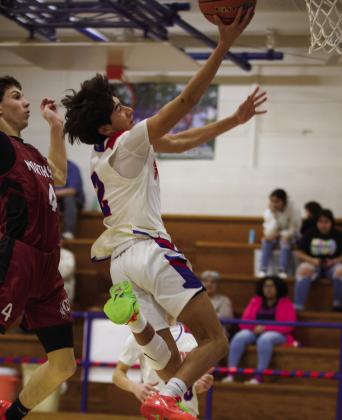 Joe Adam Morelos soars to the net with the layup | SHERI BATY PHOTO