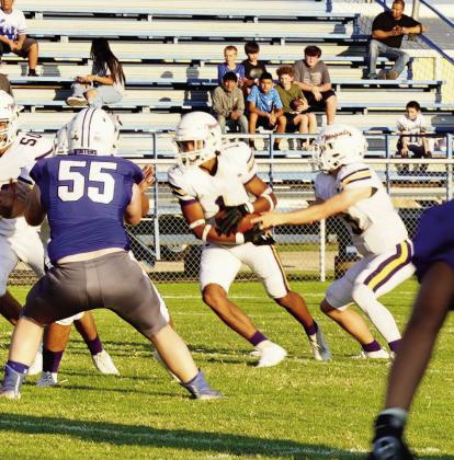 Moguls win with a final score of 41-6. Haiden Bowman hands the ball off to running back Kiyryn Wilson.