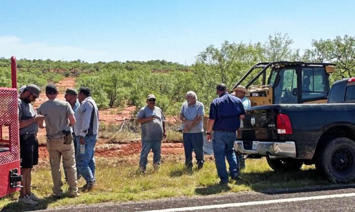 COOL-DOWN BREAK Firefighters, law enforcement and county crew members take a break to cool down and assess the fire before heading back to work or home.The fire took approximately 3 and a half hours to get under control. | TROY PARTON