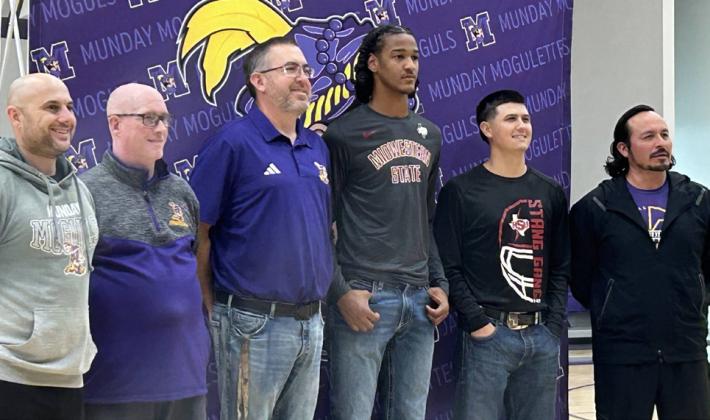 MUNDAY FOOTBALL COACHING STAFF Justin Josselet, Jon Holland, Brandon Langston, Landin Leija and Alex Rodriguez (not pictured, Drew Barnard) joined Ja’RiyisWilliams (fourth from left) at a signing ceremony last week. | COURTESY PHOTOS