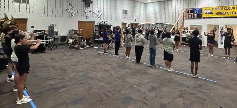POSTURE AND STANCE Munday’s new band director, Bill Blankenship, reinforces the fundamentals of being in perfect form with students in the band hall on the first day of practice.