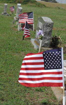 VERA—Memorial Day flags fly at the graves of veterans in the Vera Cemetery, including several who served in the Confederacy. Hanaba Munn Welch/The Knox County News-Courier