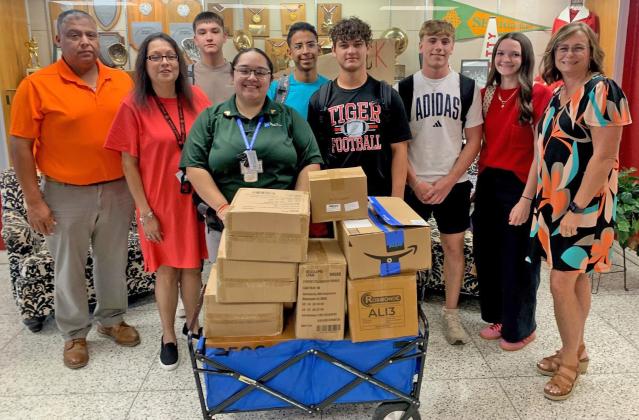 ANSON ISD RECIEVES DONATION Bluebonnet Detention Center (BDC) in Anson donated school supplies to Anson ISD on Monday, August 11, 2025. Pictured l-r BDC Warden Marcello Villegas, Ms. Ramos, back Hayden McCullough, front BDC Sgt. Marissa Rodriquez, back Zach Lomas, Brody Hall, Samuel Wilburn, Harper Dillard, and Principal Overby. | COURTESY PHOTO