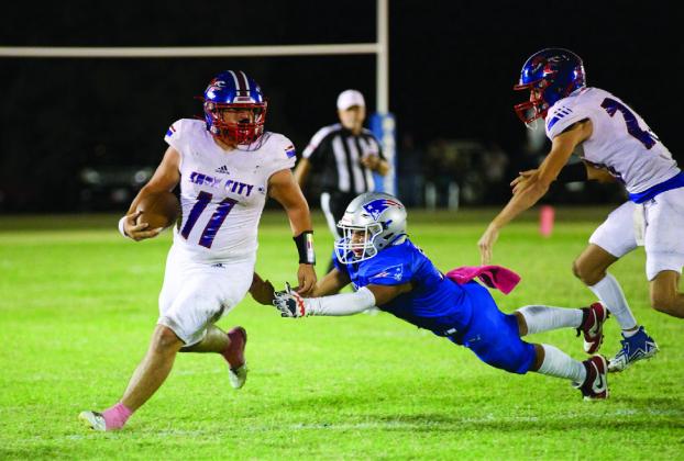 MISSING TACKLES Tristin Baxter stays one step ahead of the Patriots defender. | SHERI BATY PHOTO