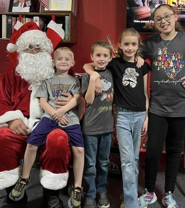 LIBRARY CHRISTMAS Santa at the library with the children that attended Christmas at the Library. See Amanda’s Library Muses on page 4 for complete story. | AMANDA BURBANK PHOTO