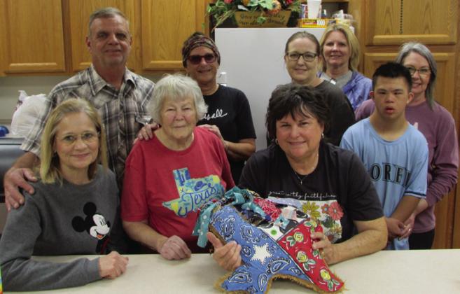 CHURCH SALE Hosts at the Methodist Church garage sale, from left – Dave Partridge, Kim Decker, Tara Cottingham, Cynthia Partridge, Isaih Decker, Leann Harlan, Nancy Tidwell, Gayle Paulus, Carla Key | DON THOMPSON PHOTOS