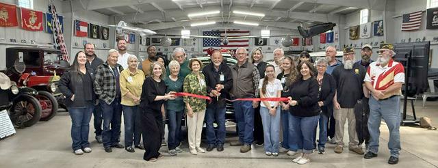 NEW MUSEUM FOR OLD VEHICLES Sam Baker cut the ribbon at the grand opening of the new location of Fort Sam Military and Antique Vehicle Museum of Haskell County, surrounded by the museum’s board of directors, spouses, family members, staff, Haskell Chamber of Commerce members, volunteers and members of the VFW Post 9179 of Stamford. | COURTESY PHOTO