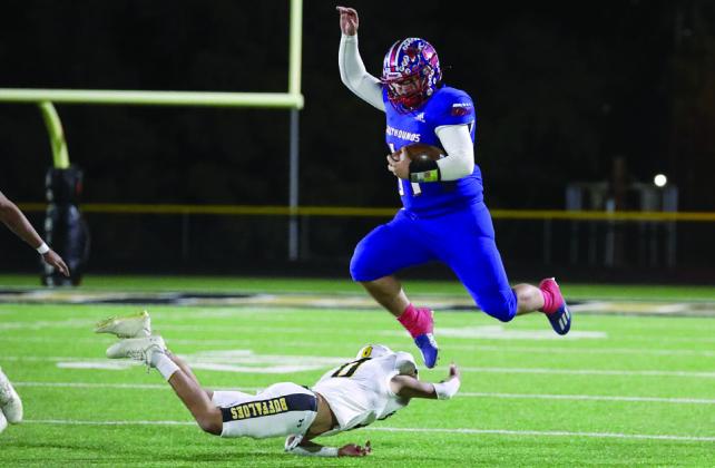 Tristin Baxter leaps over his defender Sheri Baty/The Knox County News-Courier
