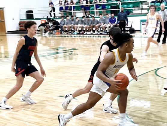 MUNDAYTUESDAYWIN #11 Junior Ethan Flye and #3 Sophomore Haiden Bowman drive the action in Munday'sbi-districtvictoryovertheRobyLions55-40TuesdayinHamlin. |SUEJANESULLIVANPHOTO
