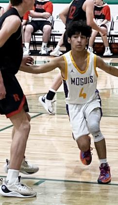 PLAYINGTHE ZONE #4 Sophomore L.J. Garcia sets up the defense in the Munday's 55-40 bi-district victory over Roby Tuesday night. | SUE JANE SULLIVAN PHOTO