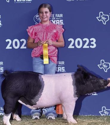 PAIGE MYERS MUNDAY FFA Braylynn Myers placed 2nd with her medium weight dark opb, and Paige Myers placed 5th with her heavy weight dark cross at the State Fair of Texas. | COURTESY PHOTO