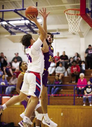 MOGULS WIN Chase Rowland reaches for the net but is met by Munday's Mance Phillips | SHERI BATY PHOTO