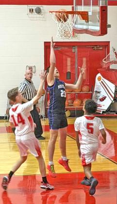 REACHING FOR THE NET Benjamin’s Everett Cates jumps high reaching for the net in the team’s matchup last Friday, Jan. 30, against the Chillicothe Eagles. The Mustangs put forth an impressive performance and defeated Chillicothe in dominating fashion, 76-14. | COURTESY PHOTO