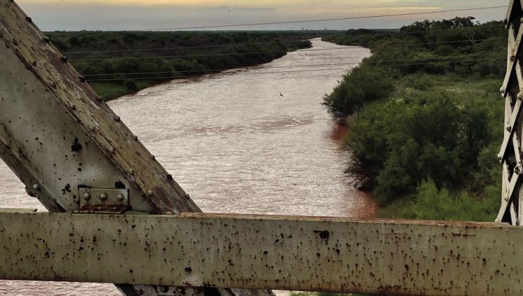 Overlooking the Brazos River flowing bank to bank.
