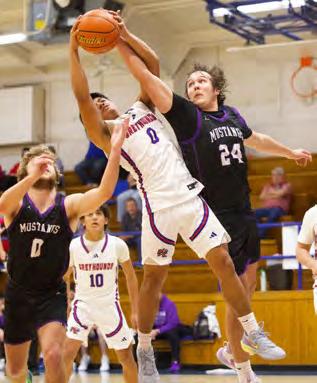 GRABANDGOREBOUND TheGreyhounds wereabletogeneratemomentumattimes, Zander Abila was in with a grab and go rebound but Benjamin pulled away to win 70-49. | SHERI BATY PHOTO