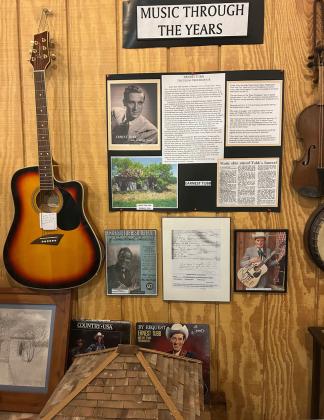 MUSICIAN ERNEST TUBB, also known as the Texas Troubadour, once called Benjamin home. A display at the Wichita-Brazos Museum boasts musical instruments, album covers and other items.