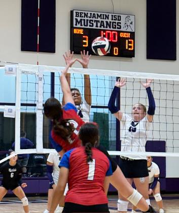 Grayson Utley, Knox City’s outside hitter, gets the kill between two defenders while teammate Jaden Baxter prepares to cover.