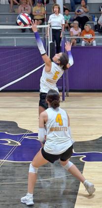 Kennedy Bosworth goes up strong at the net while Munday teammate Brooke Urbanczyk covers.