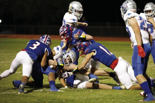 NO GAIN The Greyhound defense makes the stop. | SHERI BATY PHOTO