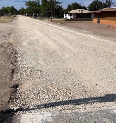 ASPHALTREADY Funded by theTexas Department of Agriculture, this road will soon be covered in asphalt; the packed down road base is ready and waiting. | TROY PARTON