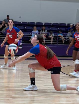 Knox City’s Grayson Utley receives service with cover from teammates Savannah Friddle and Naveah Martinez.