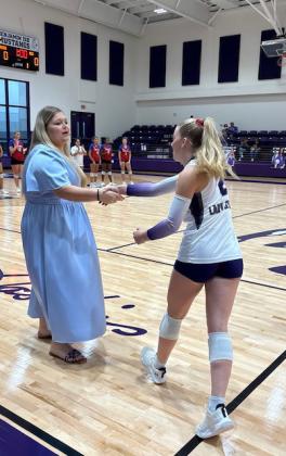 Knox City volleyball coach Kate Brown in pre-game handshake with Benjamin senior Addi Meinzer.