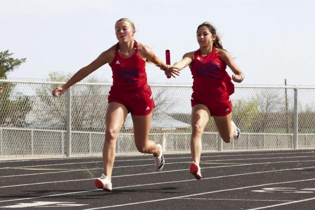 Kinlee Eaton takes the hand off from Krystabel Vasquex in the 4x100M_The Houndettes take first in district | SHERI BATY PHOTO