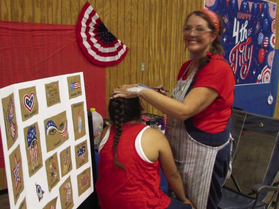 KIDS LINED UP ALL DAY for a Kacy Latham artistic face-painting. | DONTHOMPSON PHOTO