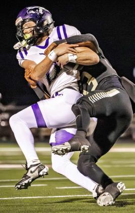 STUGGLE FOR POSSESSION Mustang’s quarterback Keegan Hayes struggles to maintain possession in last week’s regional final against Jayton.