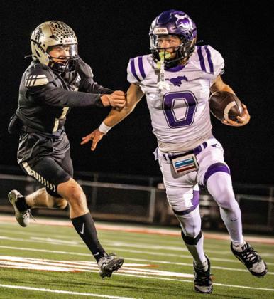 TIME TO RUN THE BALL Benjamin quarterback Keegan Hayes decides to keep the ball and run it himself in Friday night’s loss to Jayton.