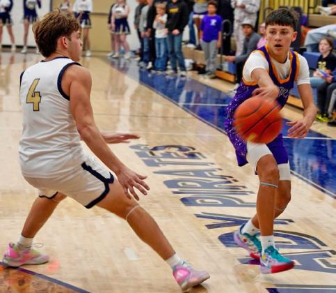 OVERTIME THRILLER Mogul Carson Willison passes the ball to the baseline in what would become an overtime thriller of a win against the Pirates.