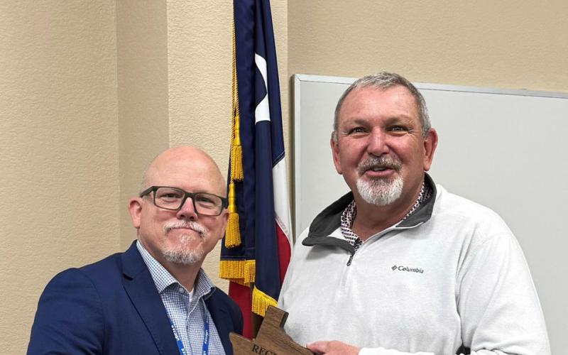 SERVICE TO EDUCATION Kenny Miller (left), deputy executive director of the Region 9 Education Service Center, was among those thanking retired Munday CISD superintendentTroy Parton for a decade-plus of service to the district. | COURTESY PHOTO