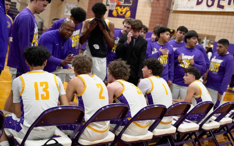 COACH DANIEL sets up an inbounds play for the Moguls during a timeout.