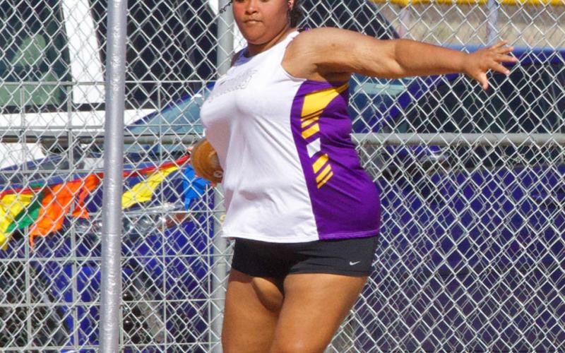 Munday competes in the discus throw.
