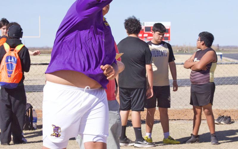 Munday competes in the shot put.