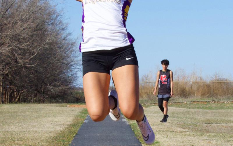 Munday competes in the long jump.