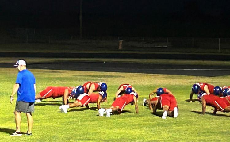 DOINGTHINGSTHEOLDWAY, seasoned coach Caleb Callaway knows what it takes—like pushups— to compete with the top dogs in six-man football, and he makes sure the players are on the same page.