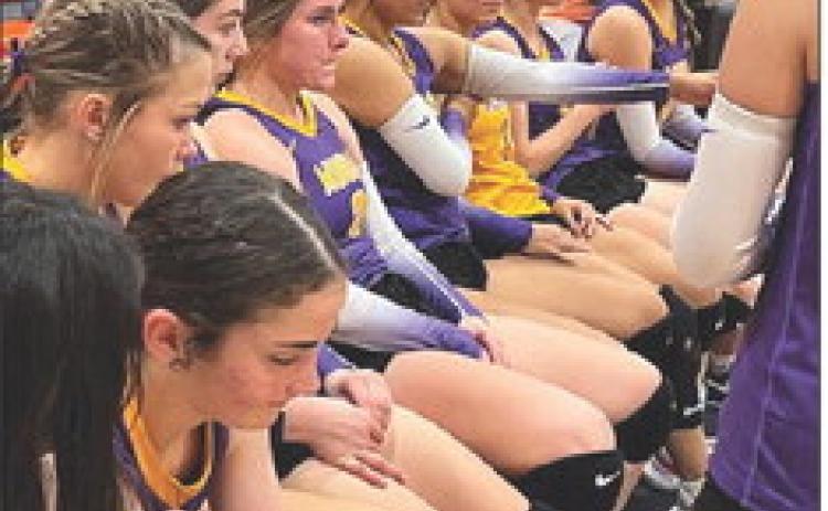 Munday players listen to Coach Burns during a timeout in Tuesday night's bi-district match with Rotan. | SUE JANE SULLIVAN PHOTO