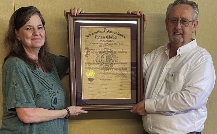 LIONSCLUBCHARTER Lions Club Secretary/Treasurer Rhonda Rogers and President DonThompson proudly display the important document. | JIM COWSERT PHOTO