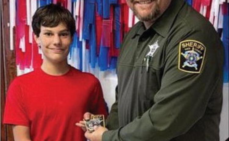 ALL GOOD DEEDS Deputy Sheriff Bridger Bush presented an award to KCJH 8th grader, Bryson Shelton for being a good citizen. Bryson was caught doing a good deed for the community last week.