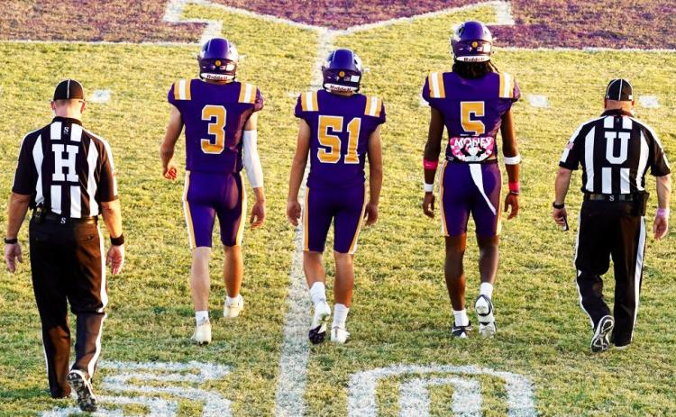 CAPTAINS MEETING Team Captains Haiden Bowman, Carson Breedlove, and Ja’RiyisWilliams meet at midfield for the coin toss. | LACI BOWMAN PHOTO