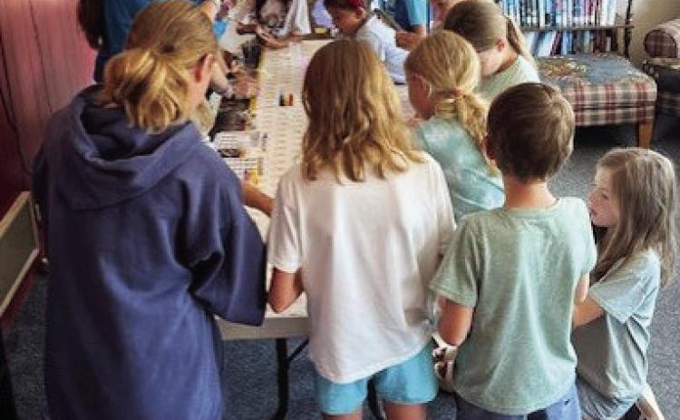 POTIONS CLASS Readers in the summer reading program at the library enjoyed making magic potions the way Harry Potter learned at the Hogwarts School ofWitchcraft andWizardry. | AMANDA BURBANK PHOTO