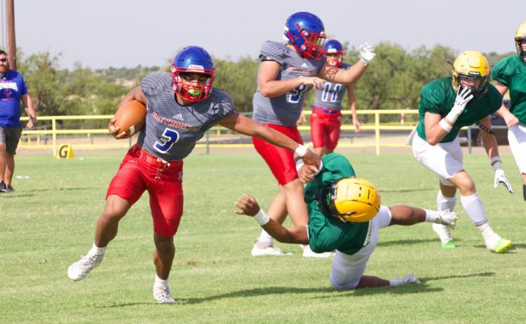 GREYHOUND ESCAPES JAGUAR Knox City’s Zander Abila slips through the grasp of the Jaguar defender during Friday’s scrimmage at Guthrie.