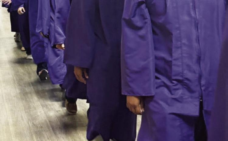 MUNDAY GRADUATES WALK HALLWAYS