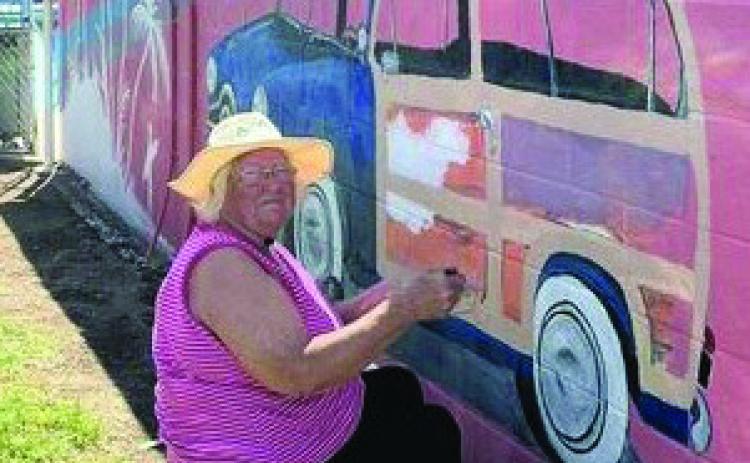 JEANIE JOHNSON PAINTS and creates beauty at the Munday Pool. Jeanie is touching up some of the pool art and is going to do her very own original painting on the right side of the pool. | COURTESY PHOTO