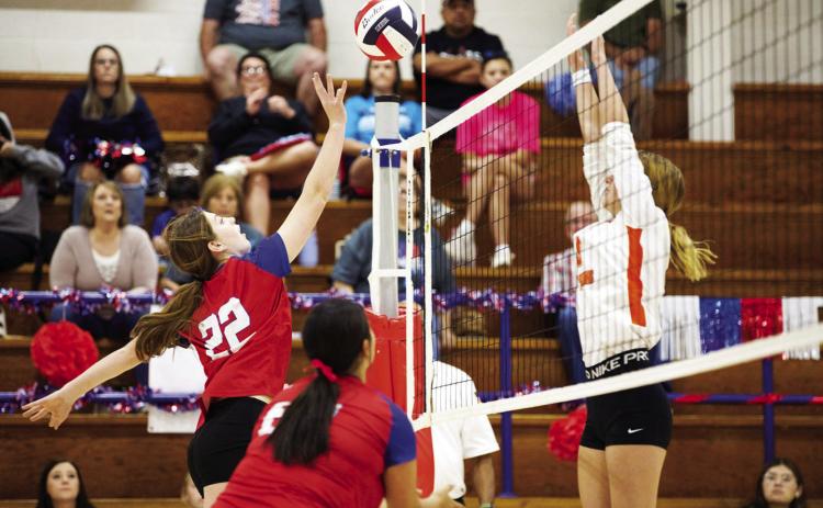 HOUNDETTES VOLLEYBALL Grayson Utley hits the ball over the net despite Paducah's attempted block. | SHERI BATY PHOTO