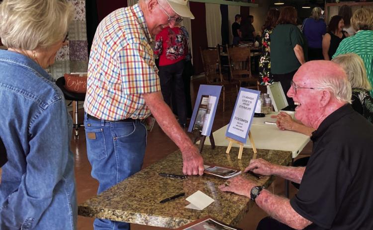 C.H. Underwood signing copies of his book “A History of the Upperforks of the Brazos River”. Photo by Sherry Hacker