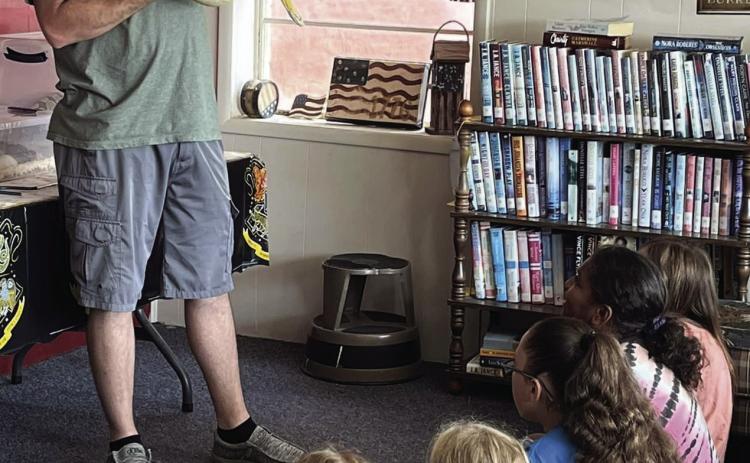 CARING FOR MAGICAL CREATURES Michael Burbank from Burbank’s Reptiles and Exotics brought some of his snakes and geckos to the Munday City-Library Summer reading program. Burbank showed the group how to care for these amazing and magical creatures. | AMANDA BURBANK PHOTO