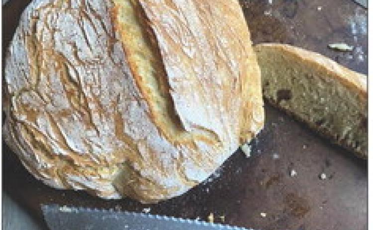 DUTCH OVEN BREAD This recipe is simple yet yields bakeryquality results with just flour, yeast, sugar, salt and water. Using a no-knead method and minimal rise time, the bread is ready in about three hours. The preheated Dutch oven creates a soft interior and crisp crust, making it a versatile and rewarding option for both beginners and experienced bakers. | ANGELINA LaRUE PHOTO