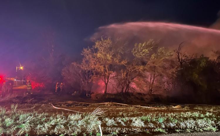 FLAMESUPPRESSION MundayVFD used a water cannon to cover the area where a two-story house once stood. | TROY PARTON